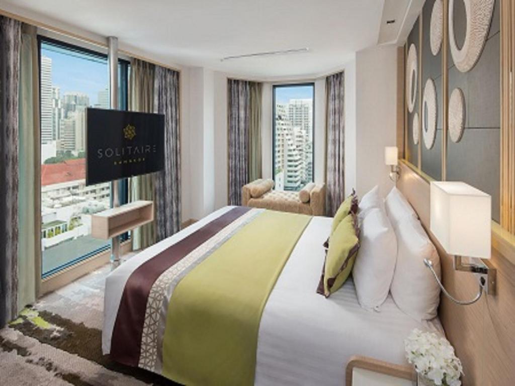Postel nebo postele na pokoji v ubytování Solitaire Bangkok Sukhumvit 11