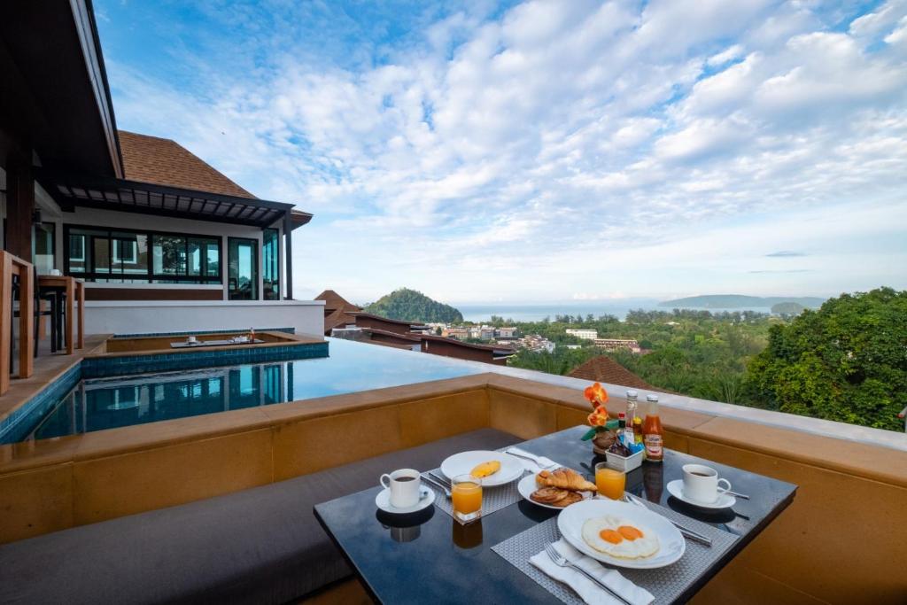 a breakfast table on the balcony of a villa at Andakiri Pool Villa Panoramic Sea View - SHA Certified in Ao Nang Beach