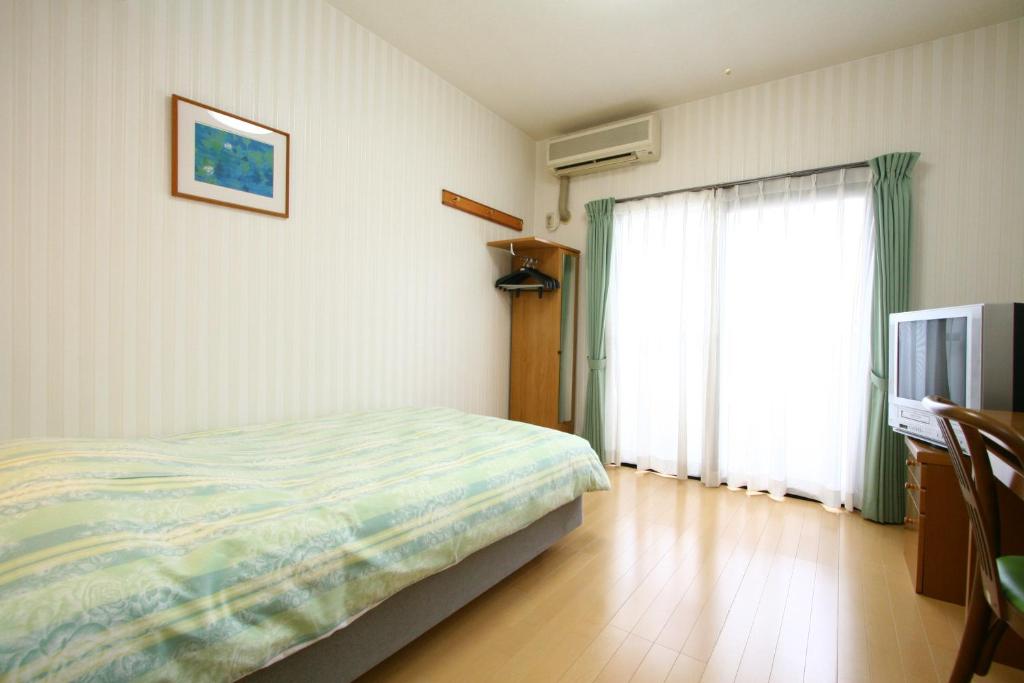 Postel nebo postele na pokoji v ubytování Accecss Tenjin