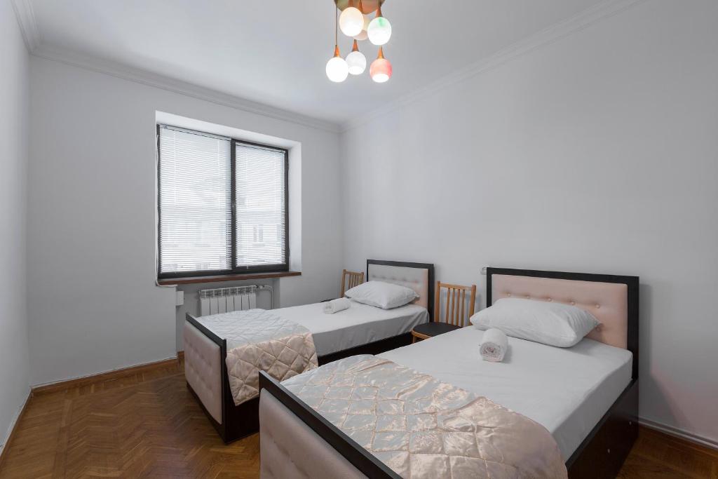 a room with two beds and a window at Umba Apartment N2 in Yerevan