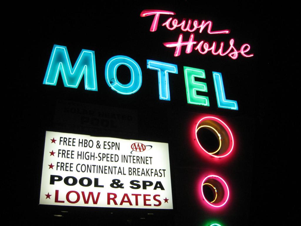 a sign for a town house motel with a neon sign at Town House Motel in Lancaster