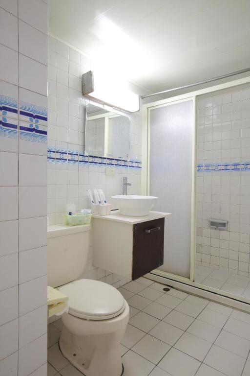 a bathroom with a toilet and a sink at Chiayi Crown Hotel in Chiayi City