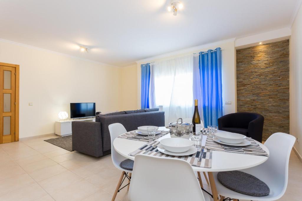 a dining room with a white table and chairs at Pedros Apartment by Seewest in Lagos