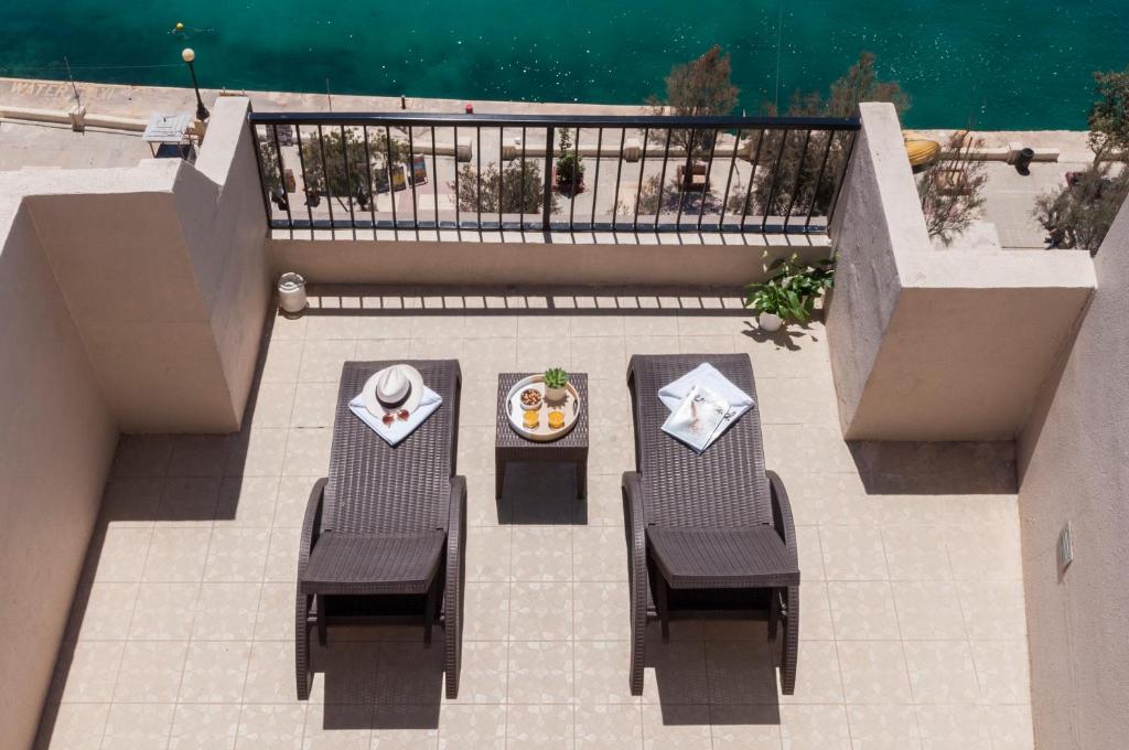 Elle offre une vue sur la terrasse dotée de 2 chaises et d'une table. dans l'établissement Sliema Hotel by ST Hotels, à Sliema