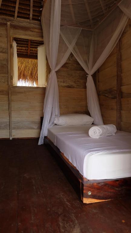 Letto o letti in una camera di Beranda Ecolodge