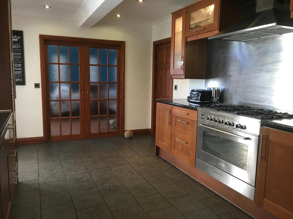a kitchen with a stainless steel stove top oven at Craster Crew House in Craster