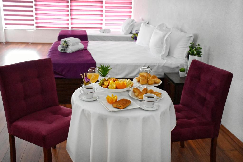 a hotel room with a table with a tray of food at Hotel and winery LOZAR in Bitola