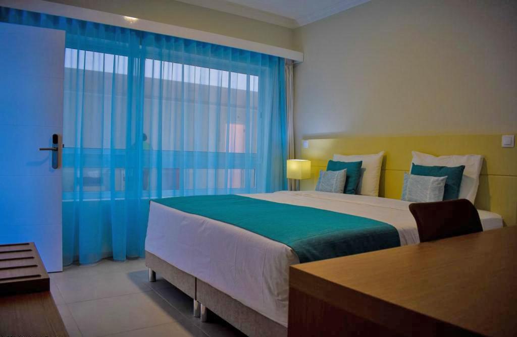 Postel nebo postele na pokoji v ubytování Tiduca Hotel