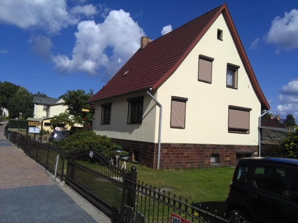 a large white house with a red roof at Gartenidyll in Ostseebad Koserow