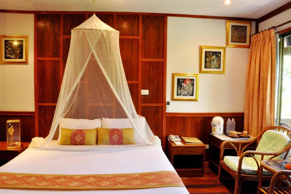 A bed or beds in a room at Phi Phi Natural Resort