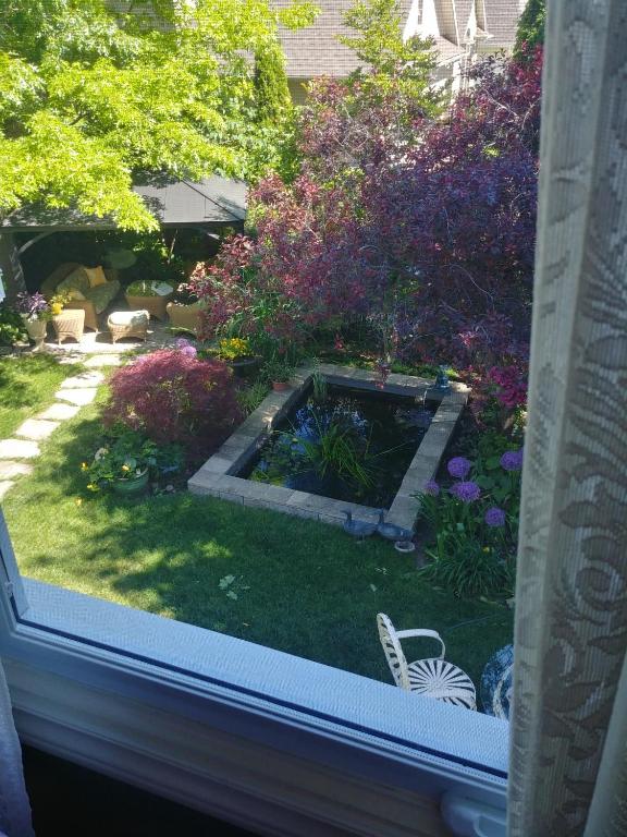 a view of a garden from the window of a house at TwiningRetreat in Niagara-on-the-Lake