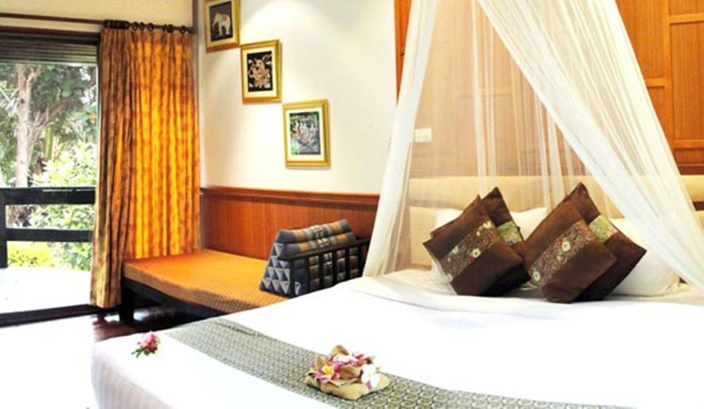 A bed or beds in a room at Phi Phi Natural Resort