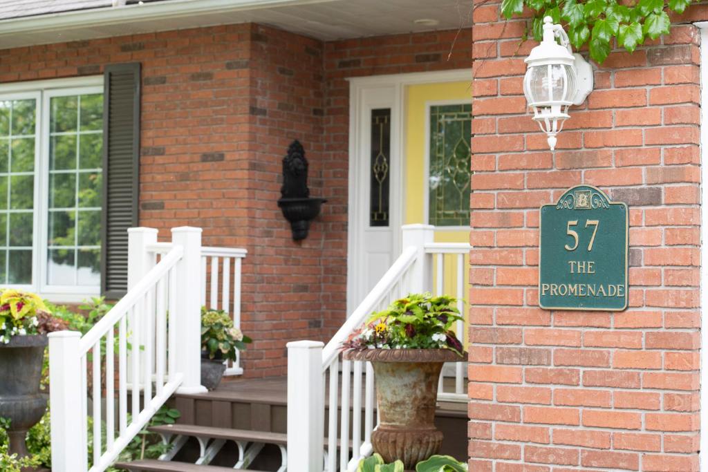 a brick house with a sign on the side of it at TwiningRetreat in Niagara-on-the-Lake