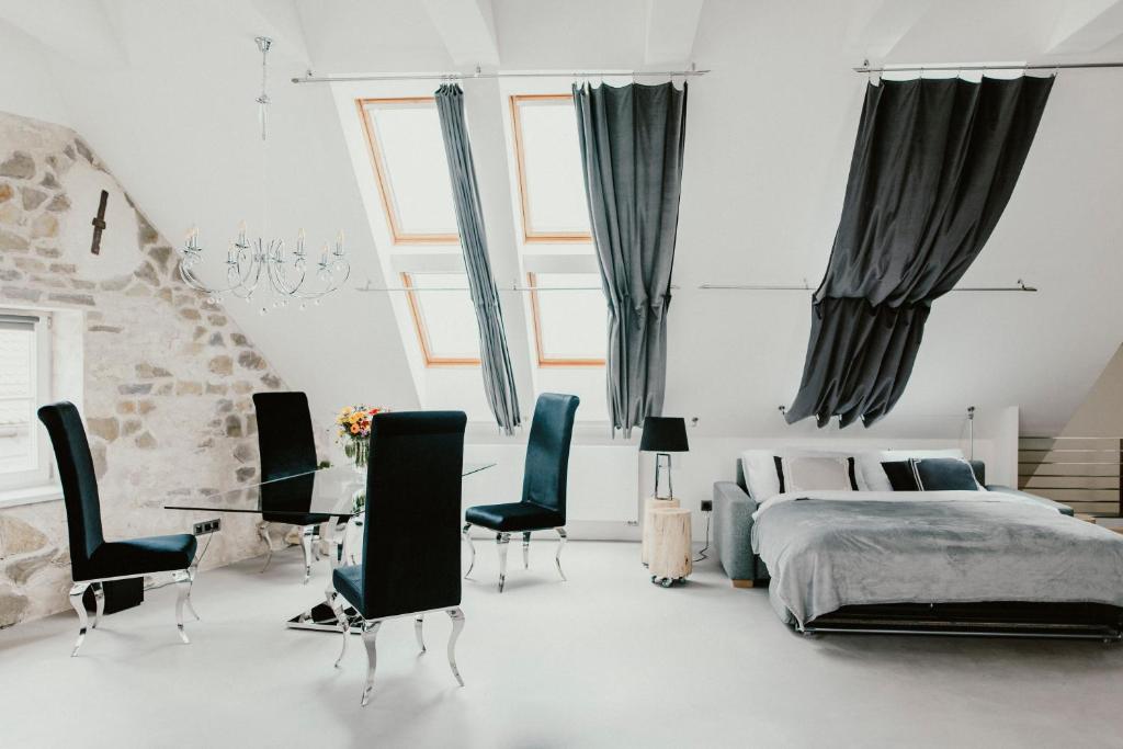 a bedroom with a bed and a table and chairs at Coco Chanel Boutique Apartment in Brno