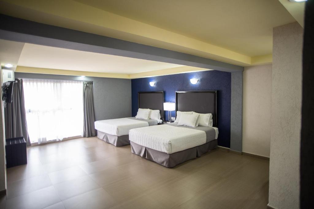 Postel nebo postele na pokoji v ubytování Hotel Ha