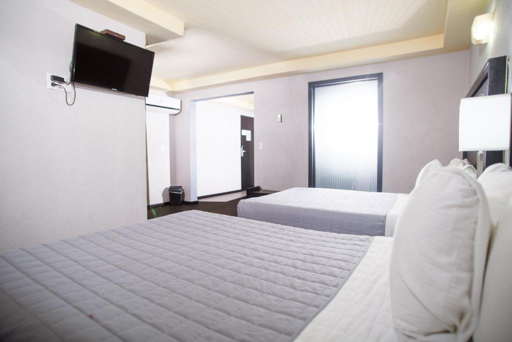 Postel nebo postele na pokoji v ubytování Hotel Ha