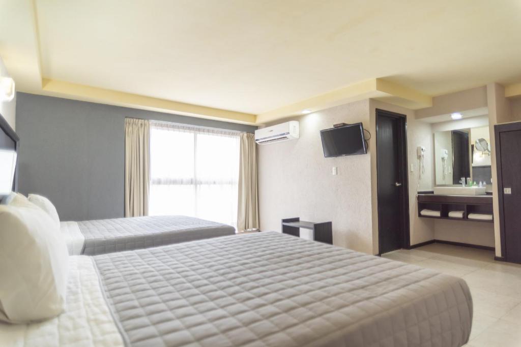 Postel nebo postele na pokoji v ubytování Hotel Ha