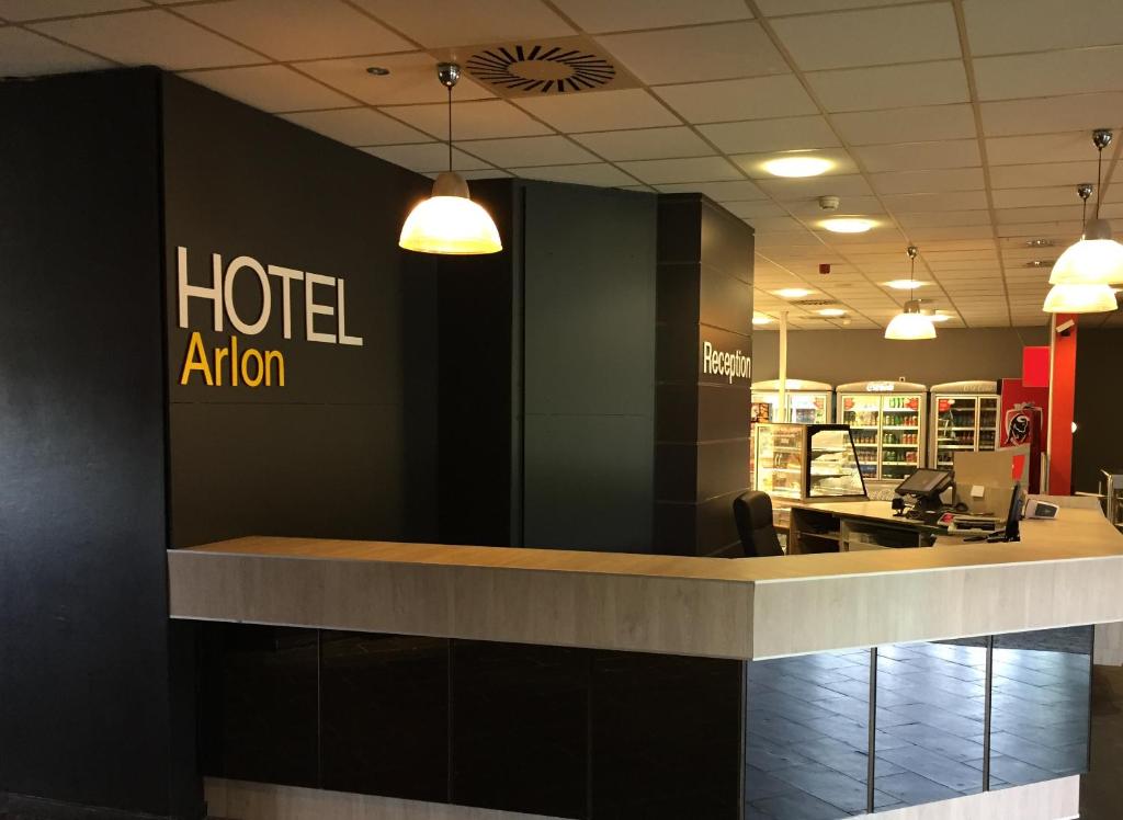 a kitchen with a barber shop and a counter top at Hotel Arlon in Arlon