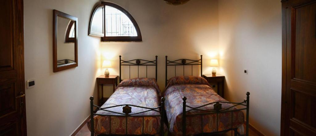 Postel nebo postele na pokoji v ubytování Agriturismo Le Case