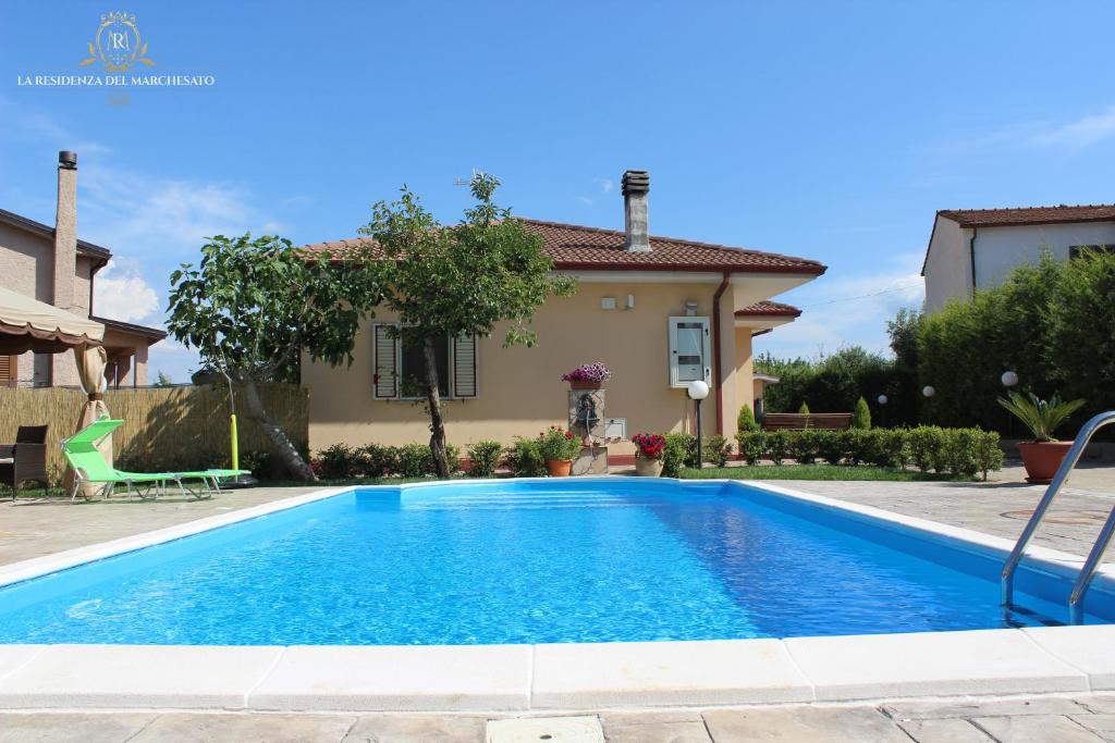 a swimming pool in front of a house at La Residenza del Marchesato in Marano Marchesato