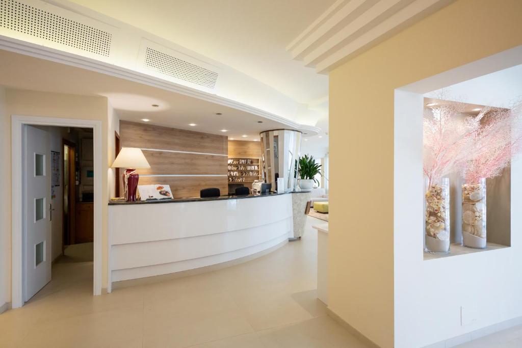 a large hallway with a bar in a house at International Beach Hotel in Caorle