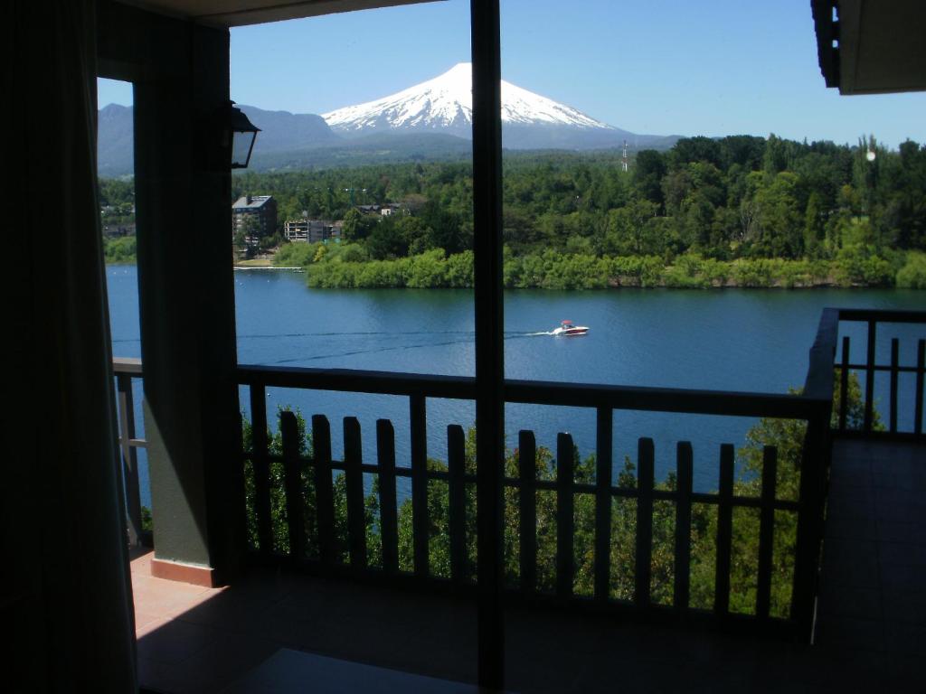 a view of a snow covered mountain from a balcony at La Peninsula Rehue in Pucón