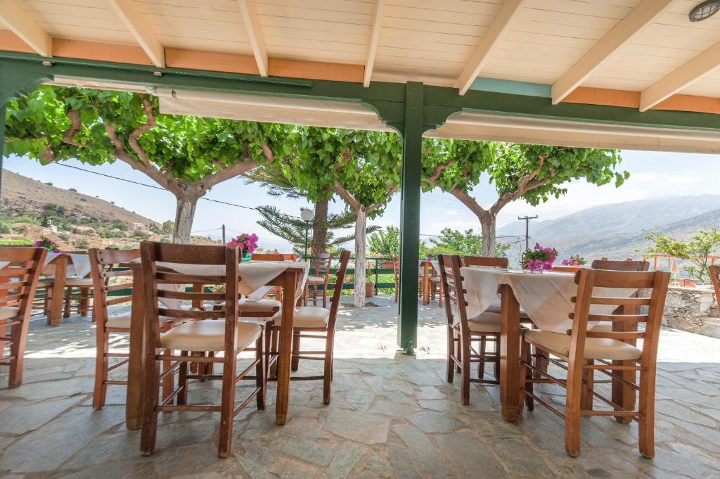 a table and chairs under a pergola with a view at Harma - Grand Sea & Mountains View in Exopoli