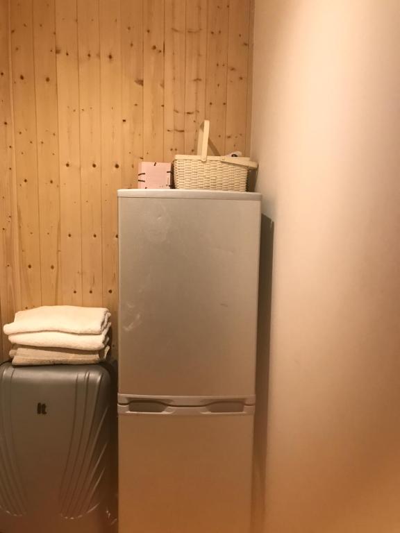 a refrigerator with towels sitting on top of it at Graceland Woolwich in Woolwich