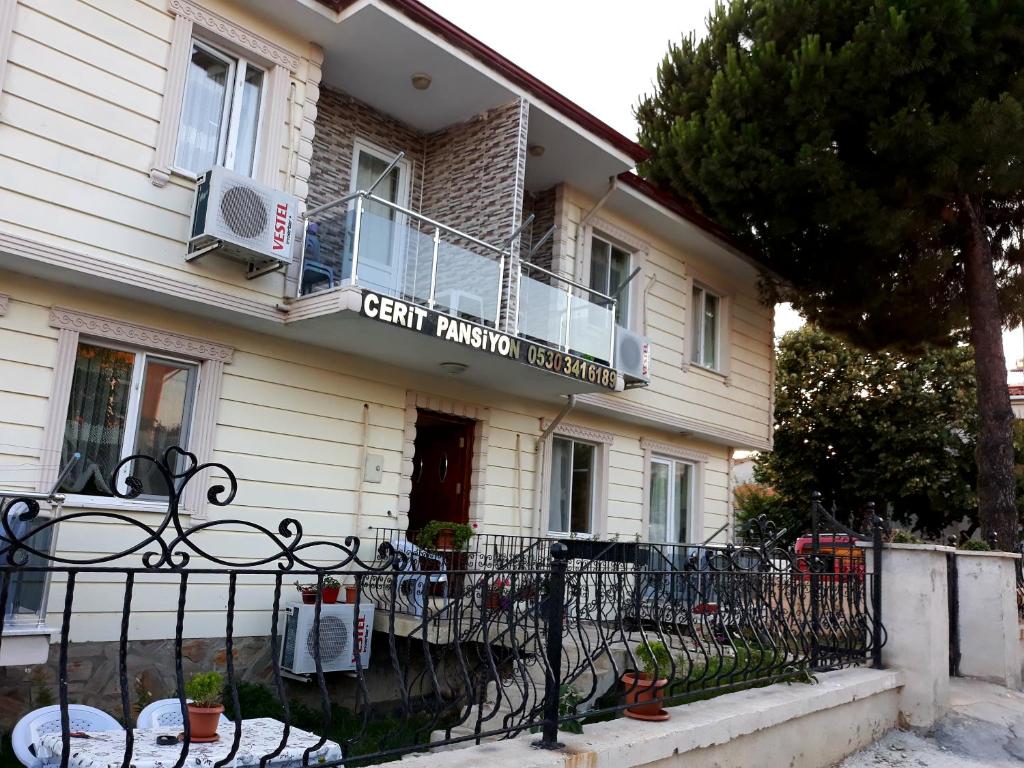 a building with a fence in front of it at Cerit Pansiyon in Gokceada Town