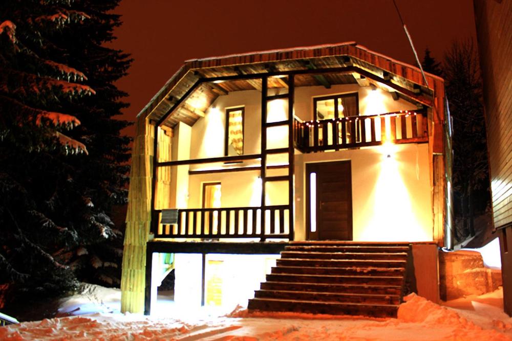 a small house with stairs in the snow at Sunshine Dreams Villa Jahorina in Jahorina