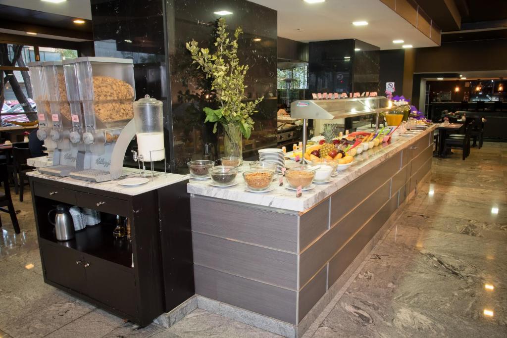 A long self-service buffet with cereals, fruit, cold dishes and drinks.