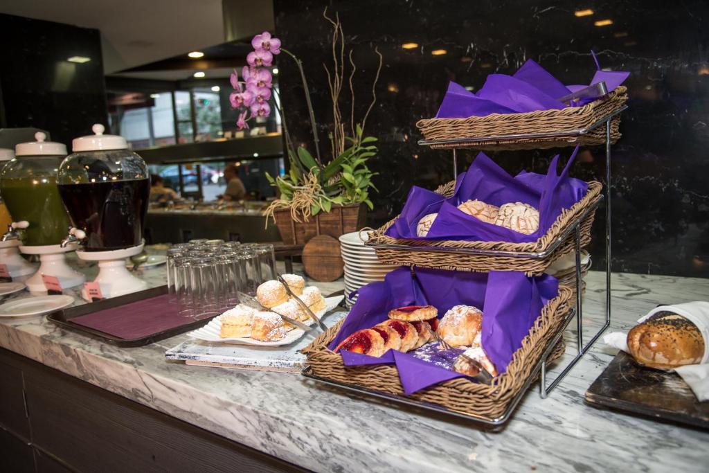 A bread-and-pastry station beside juice dispensers and coffee service.