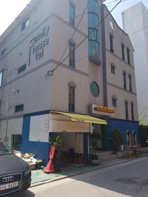 a building on a street with a cone in front of it at Family House Hongdae in Seoul