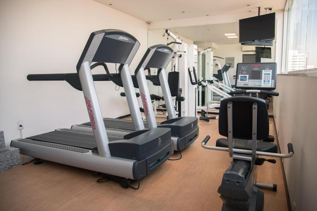 A treadmill-focused gym with three visible treadmills and a seated machine.