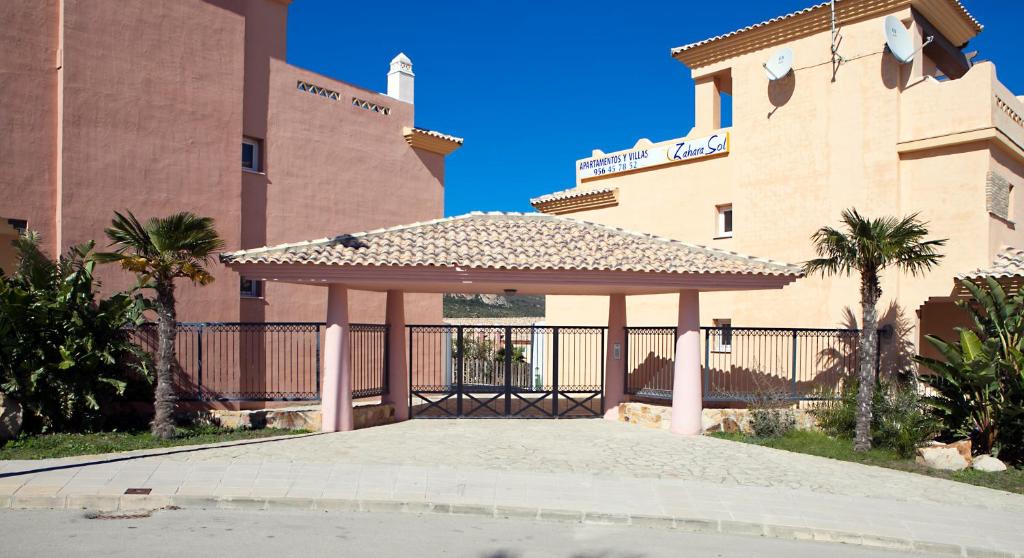a gazebo in front of a building at Zahara Sol Villas y Apartamentos by QHotels in Zahara de los Atunes