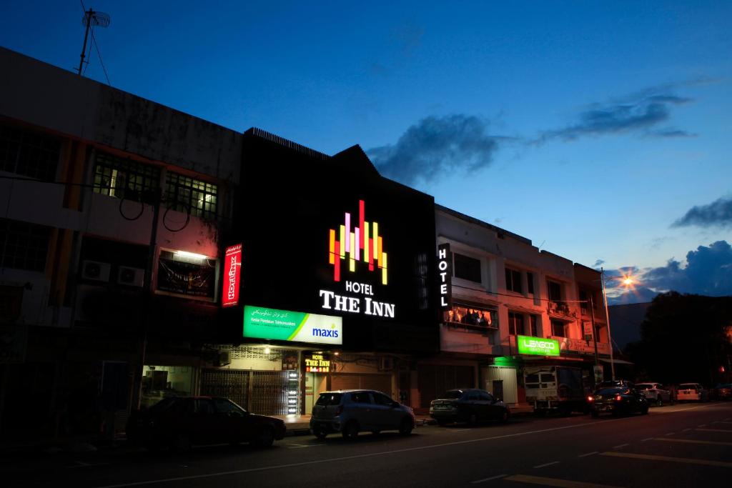 a building with a sign that reads new tree inn at The Inn Hotel in Kuala Terengganu