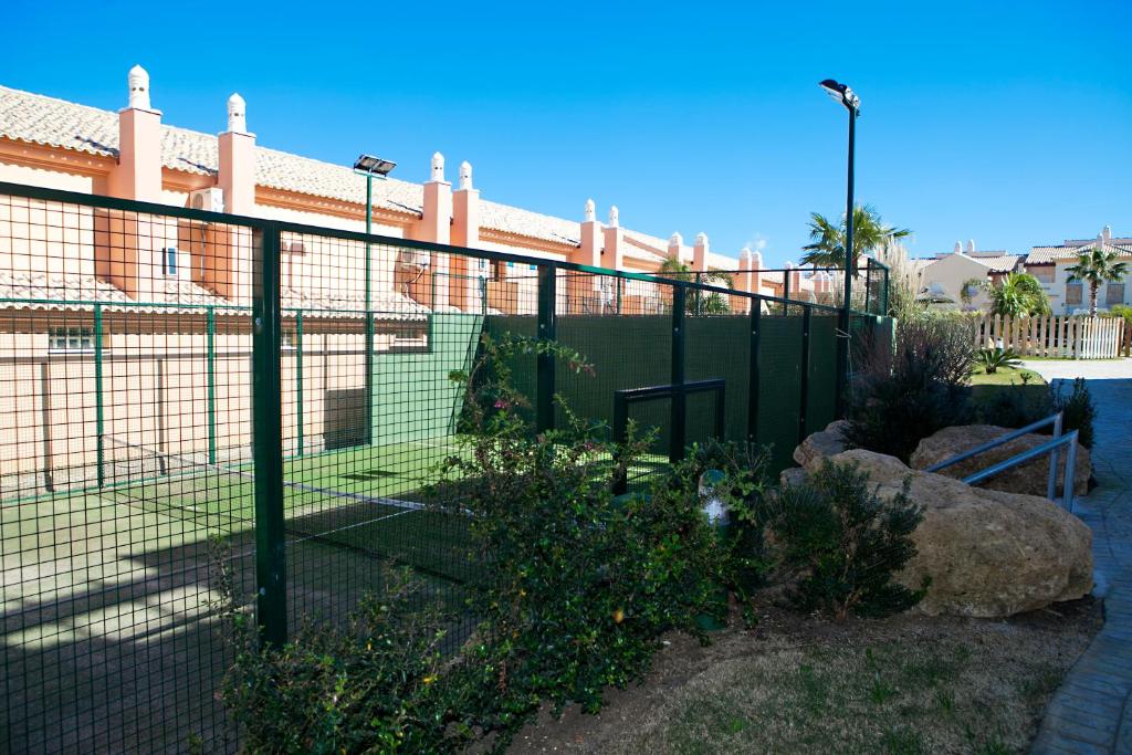 a fence in front of a building at Zahara Sol Villas y Apartamentos by QHotels in Zahara de los Atunes