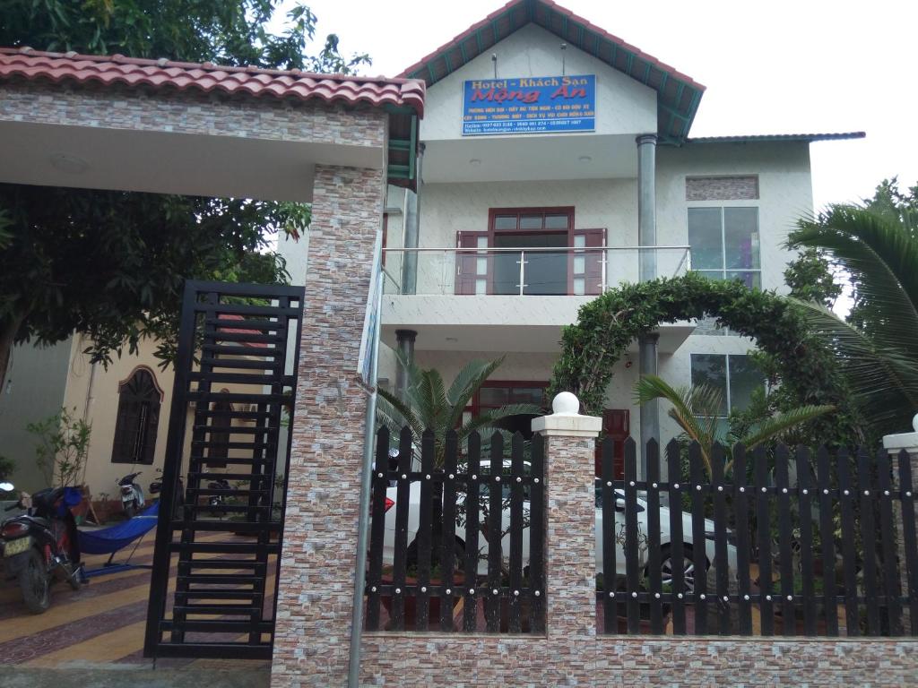 una casa con una valla negra y una puerta en Khách sạn Mộng An en Vĩnh Hy
