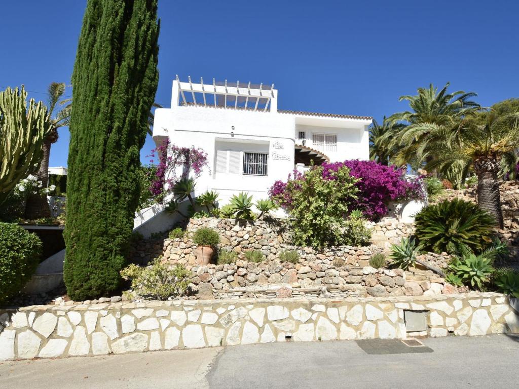 a white house with some plants and trees at Belvilla by OYO Casa Patricia in Altea la Vieja