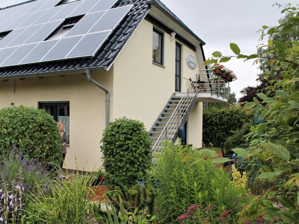 a house with solar panels on the roof at Spacious Apartment in Boltenhagen with Garden in Tarnewitz