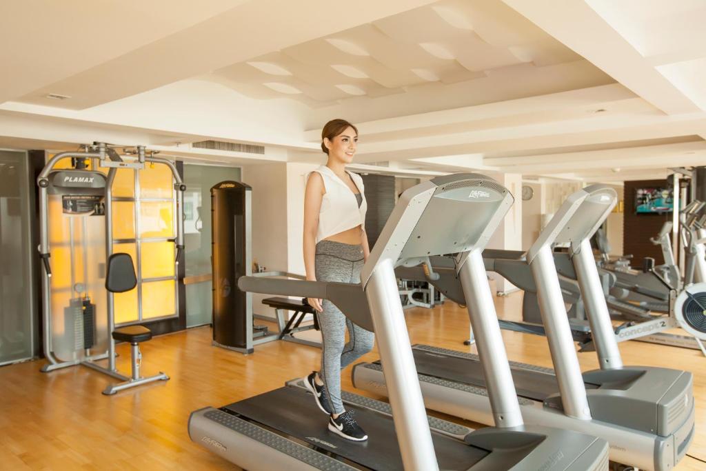 A bright fitness room with treadmills and strength equipment.