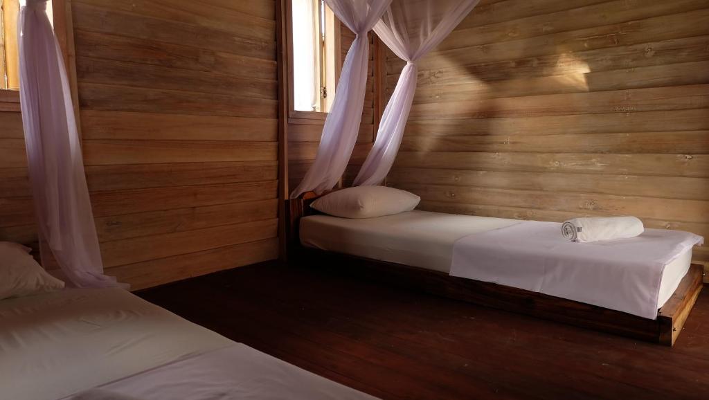 Letto o letti in una camera di Beranda Ecolodge