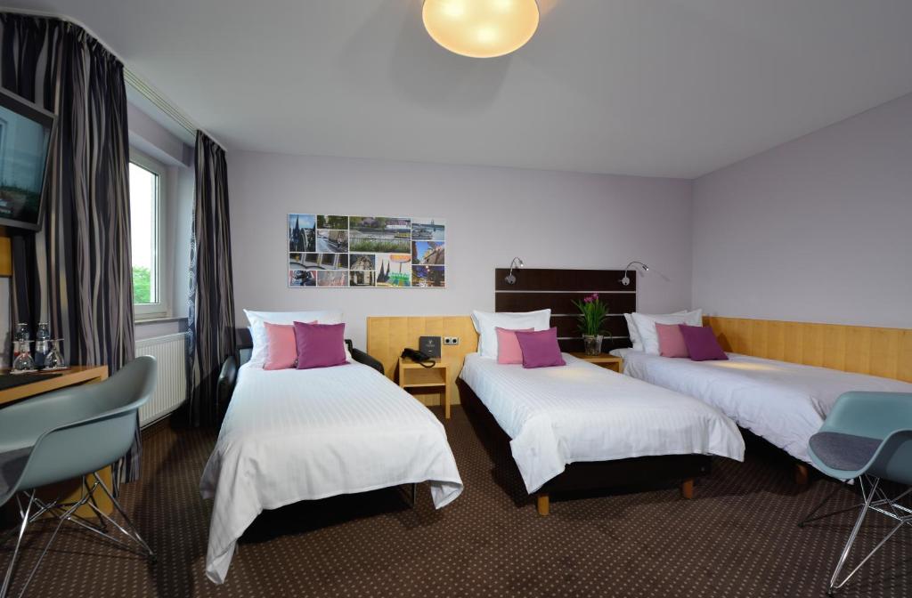 Postel nebo postele na pokoji v ubytování Hotel Uhu Garni - Superior