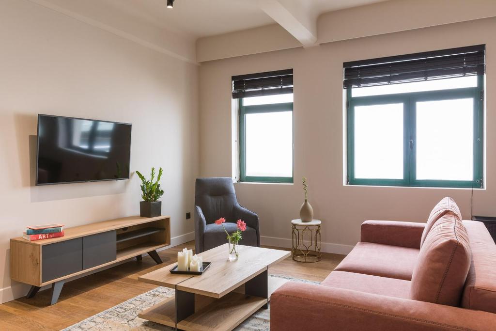 TV a/nebo společenská místnost v ubytování Klepsydra Urban Suites