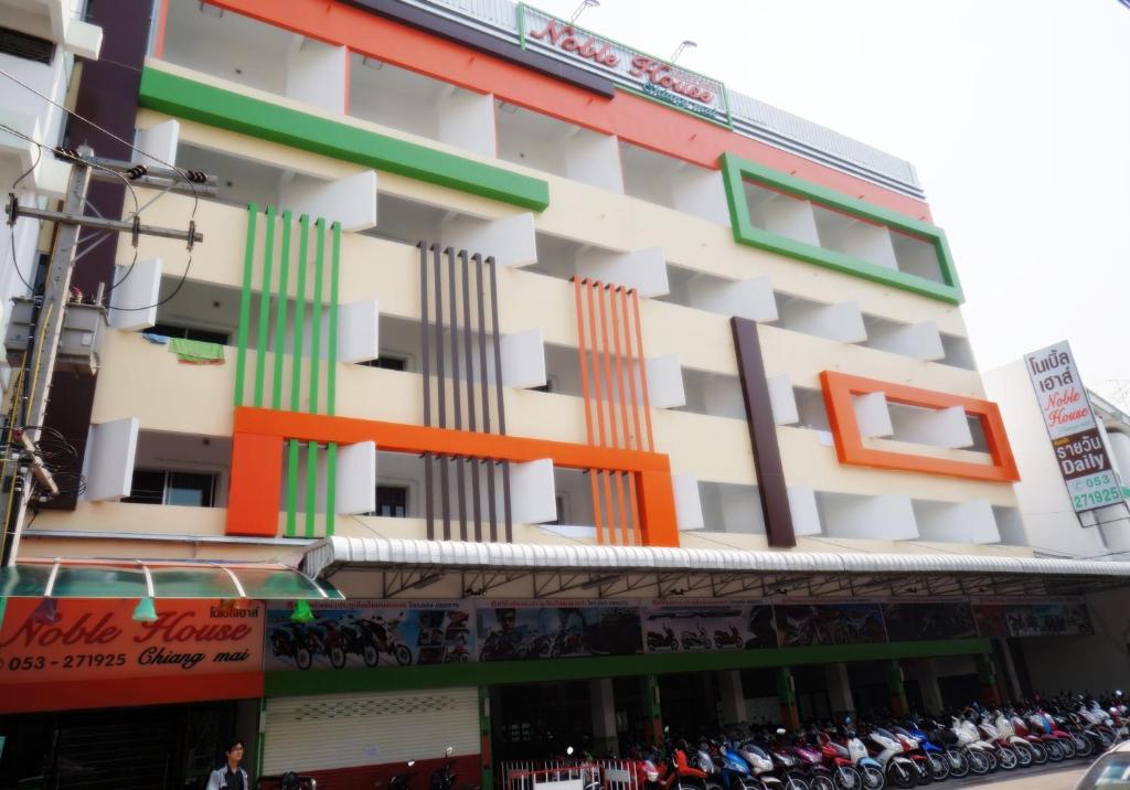 a building with colorful windows on the side of it at Noble House Chiangmai in Chiang Mai