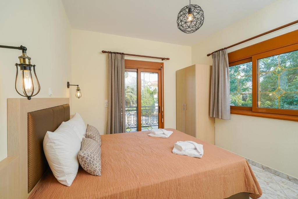 a bedroom with a bed with two towels on it at Villa Karydies in Limenas
