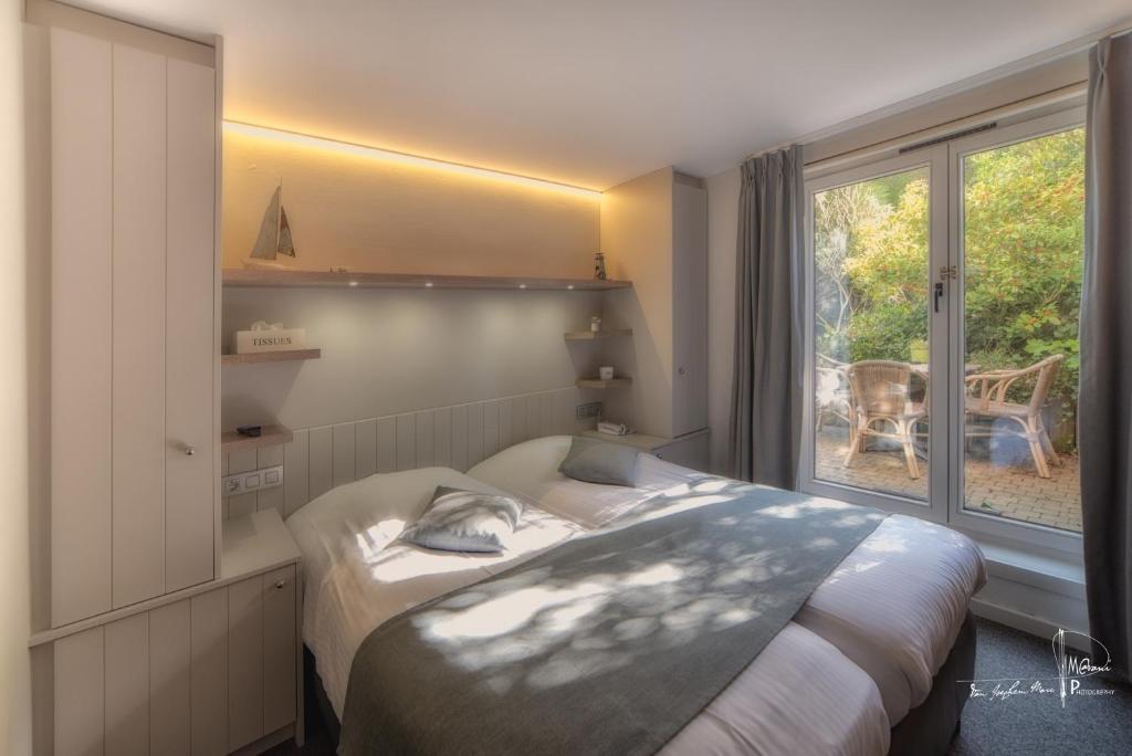 Postel nebo postele na pokoji v ubytování Hotel Bilderdijk