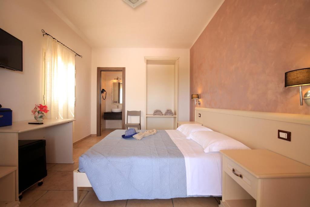 a bedroom with a large bed and a television at B&B Hibiscus in Vieste