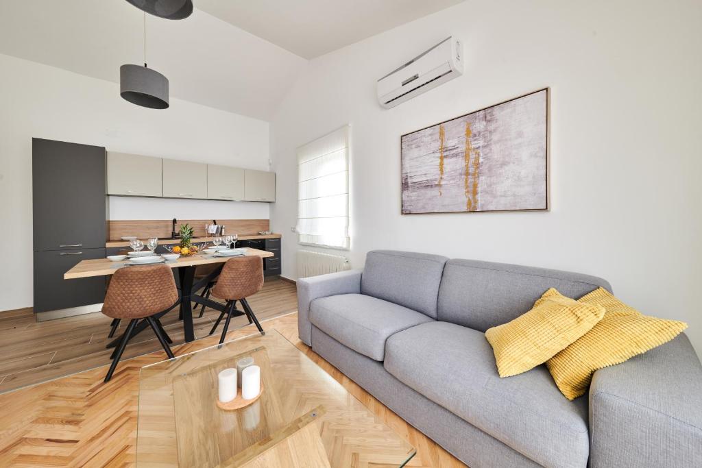 a living room with a couch and a table at Ribarska Koliba - Villa Marija in Pula