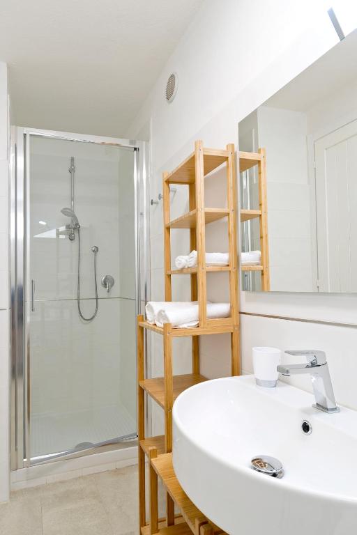 a bathroom with a sink and a shower with a glass door at Dimora Simius in Villasimius